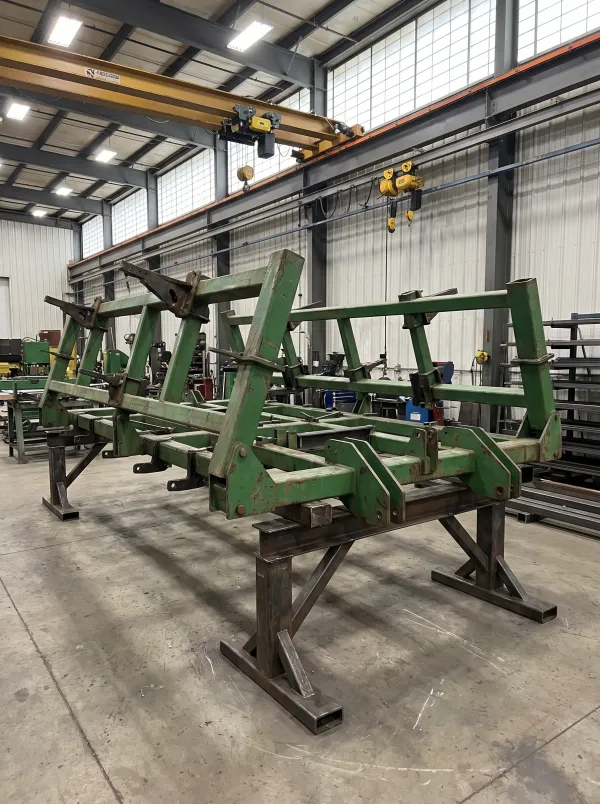 Welded steel frame of a planter implement being assembled on a factory floor